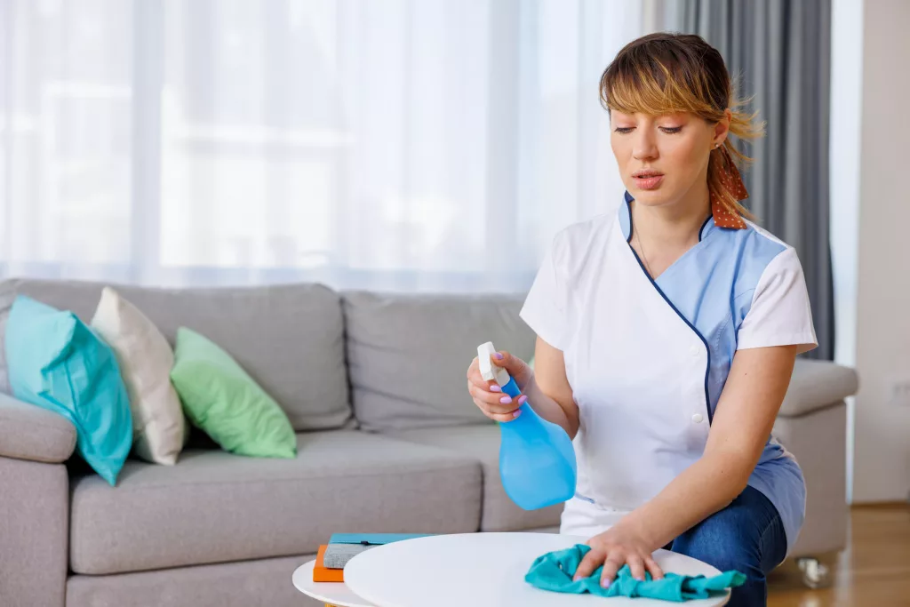 Picture of a professional cleaning the table